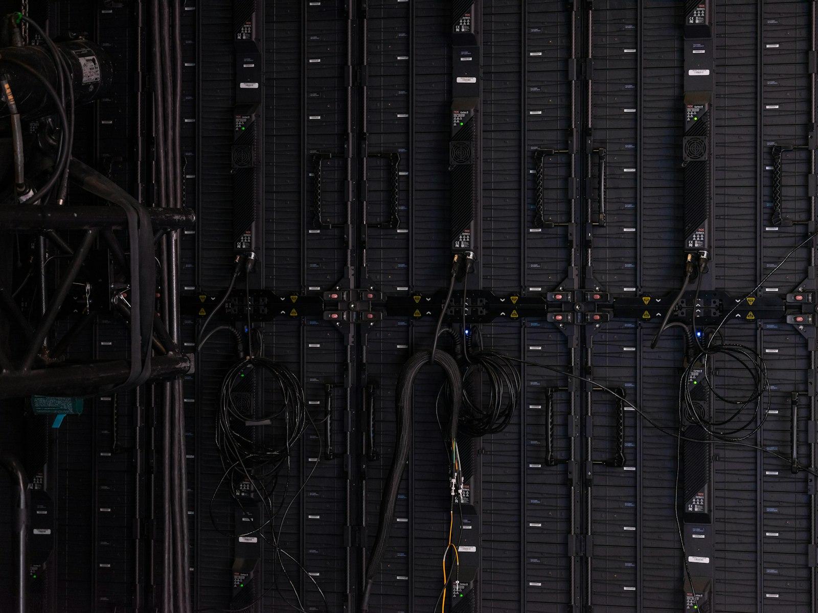 Close-up of black cables and wires connected to server hardware in a data center