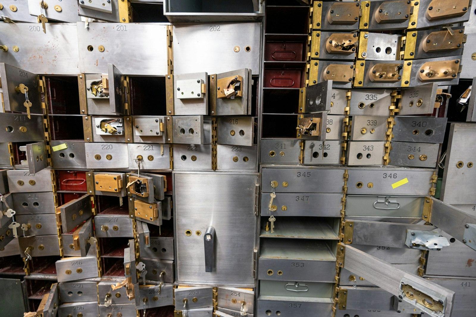 Empty gray stainless steel safe deposit boxes inside a bank vault