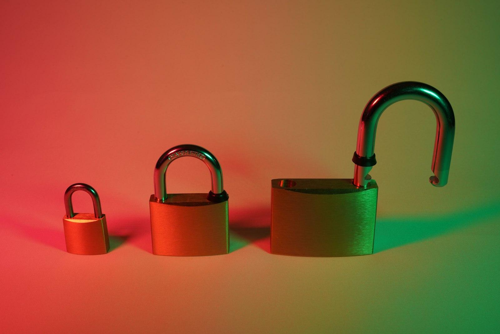 Several padlocks of different colors hanging together, symbolizing layered security