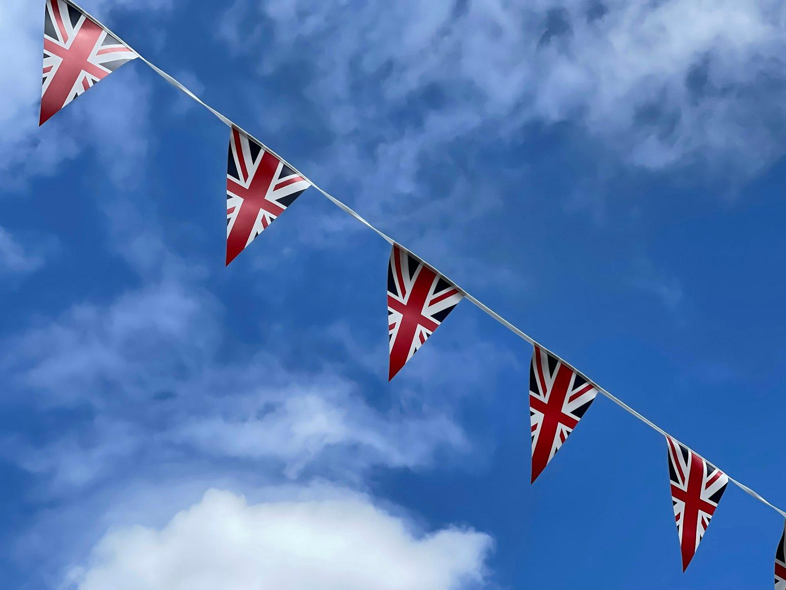 Colorful Union Jack bunting flags strung together against the sky during Queen's Platinum Jubilee celebrations