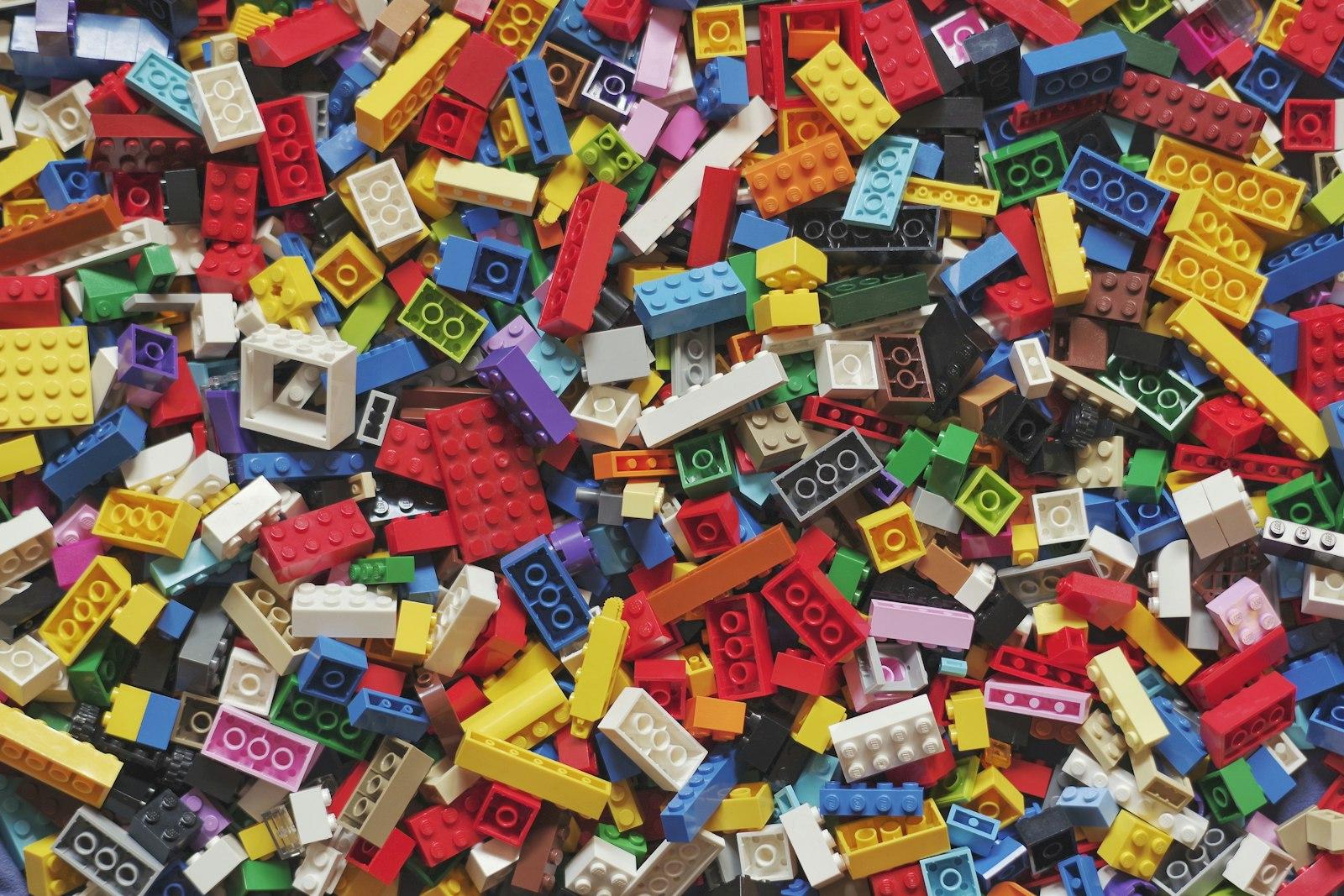 Colorful LEGO bricks in yellow, red, blue, and green arranged together