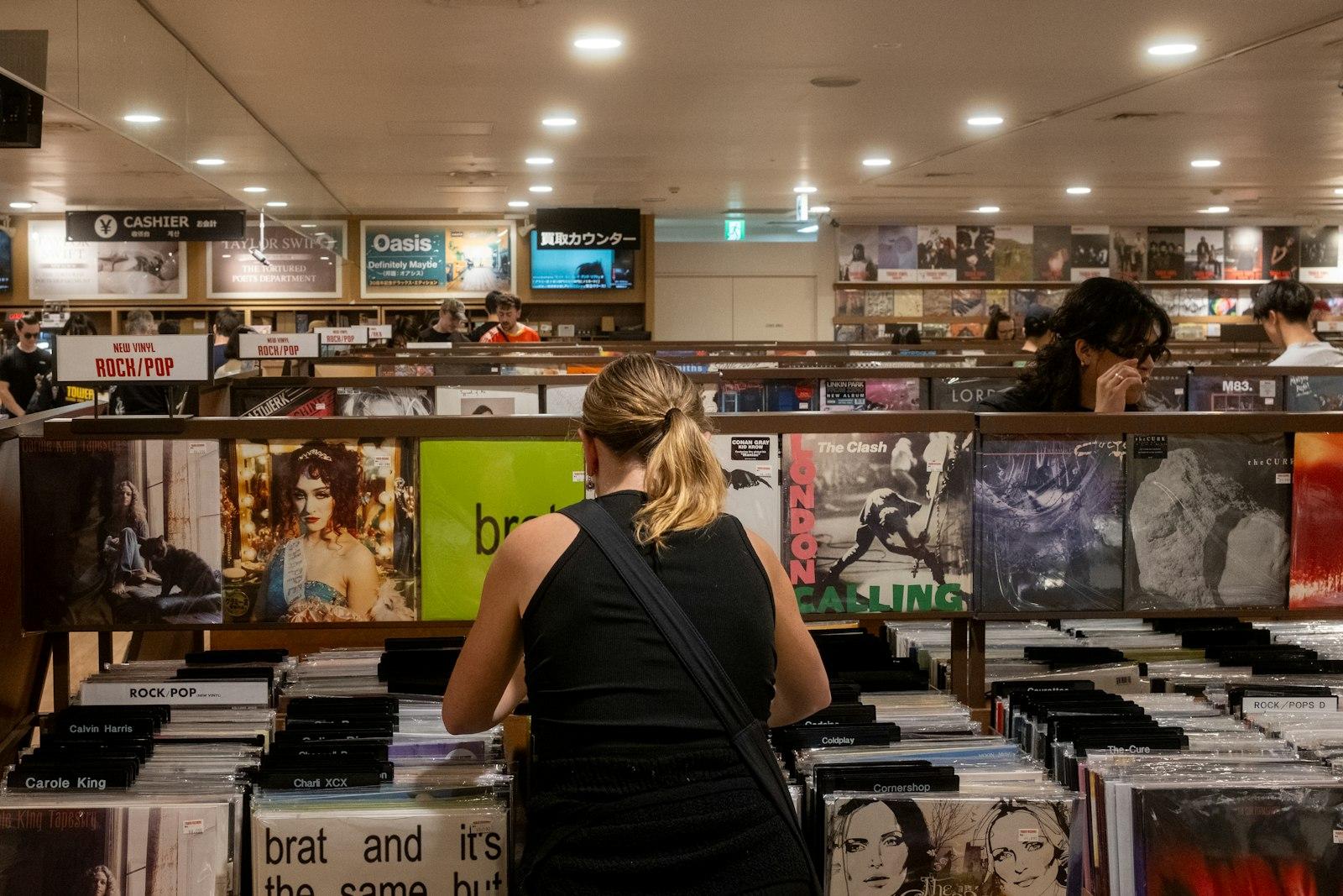 A woman browsing vinyl records in a record store